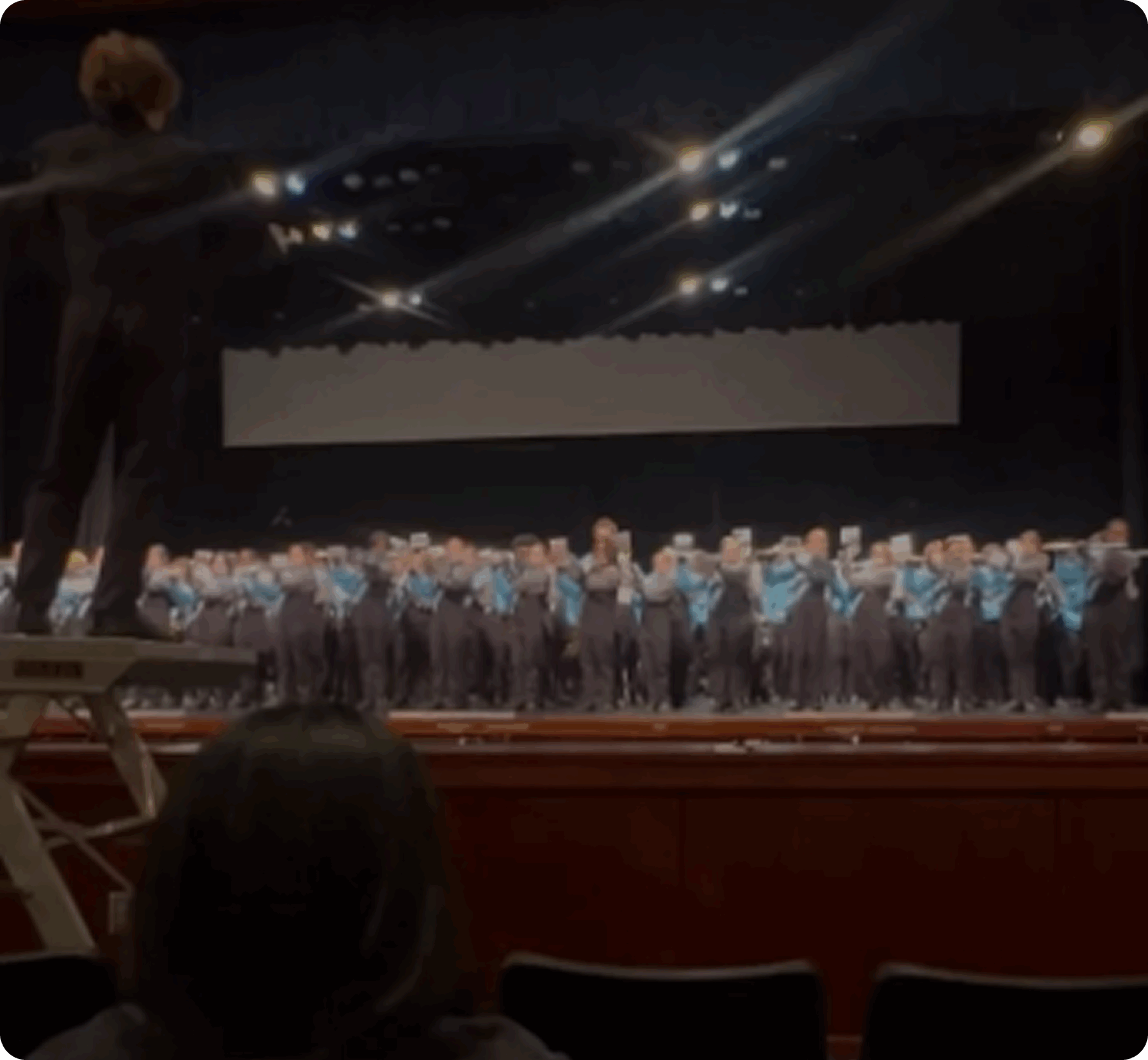 Choir performance with conductor on platform
