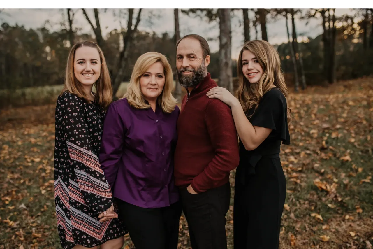 Smiling family in a wooded area