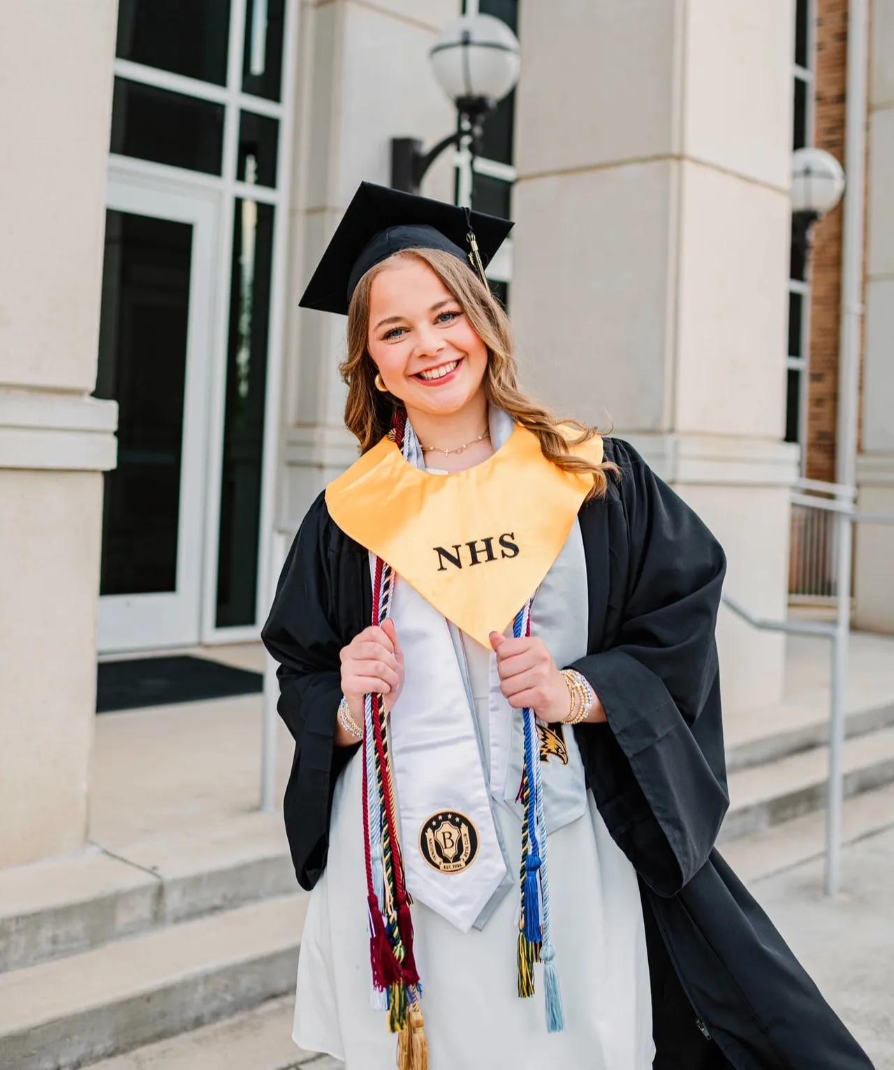 Graduate smiling in cap and gown