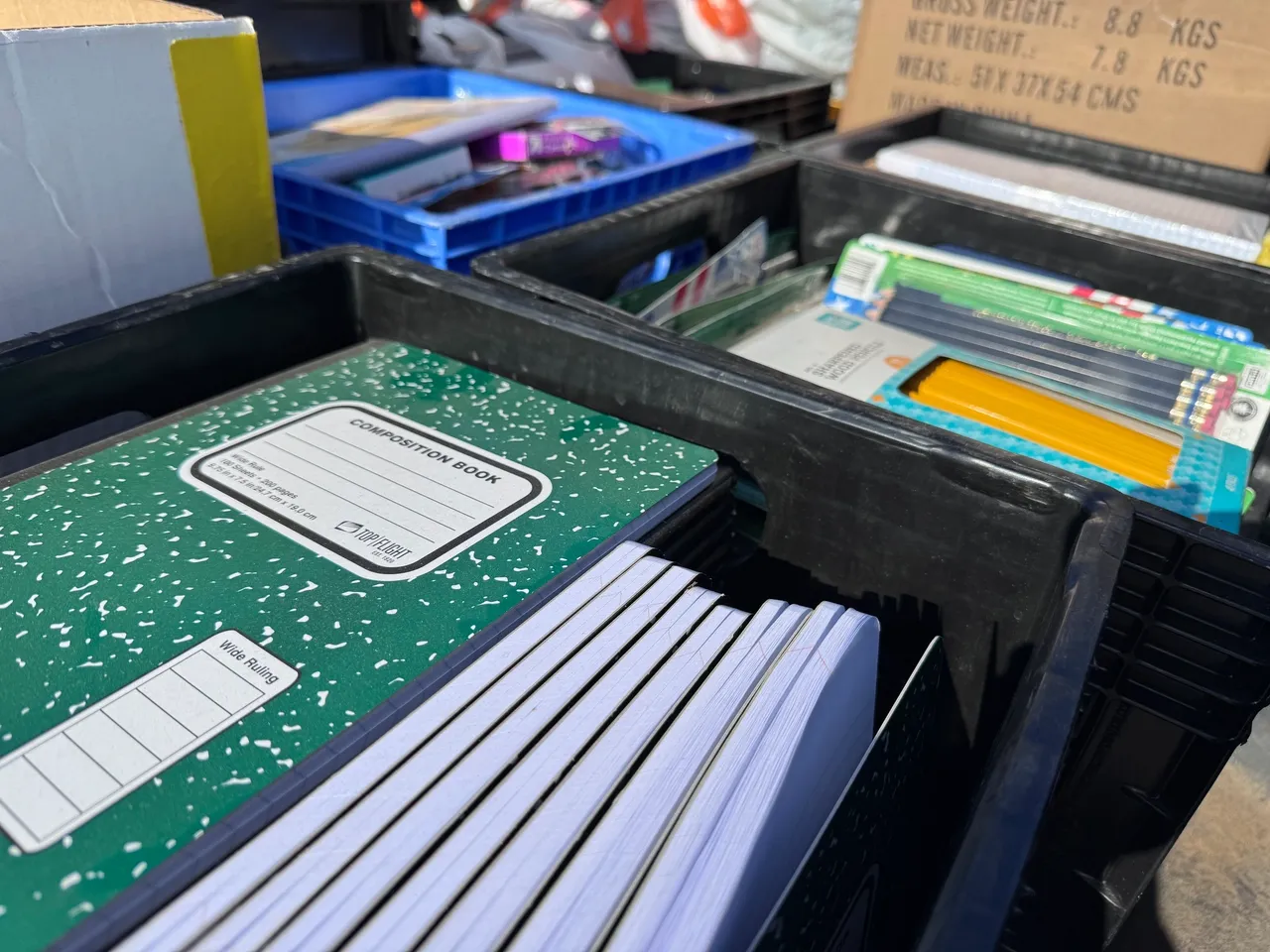 School supplies organized in black bins
