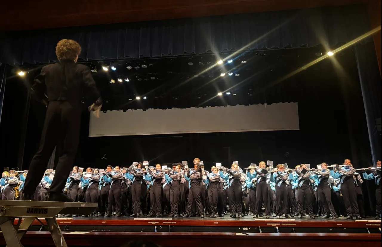Conductor leads band on stage