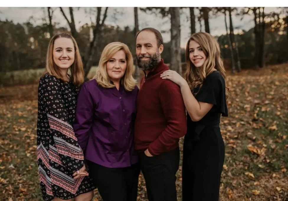 Smiling family in a wooded area