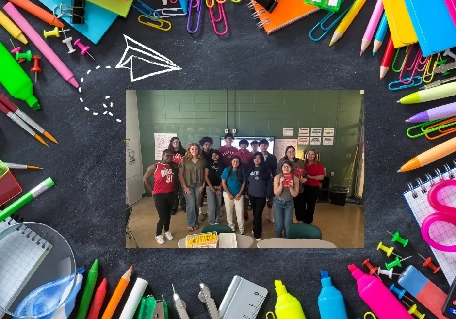 Students posing in classroom with stationery border.