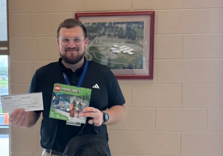 Man holding LEGO set and check