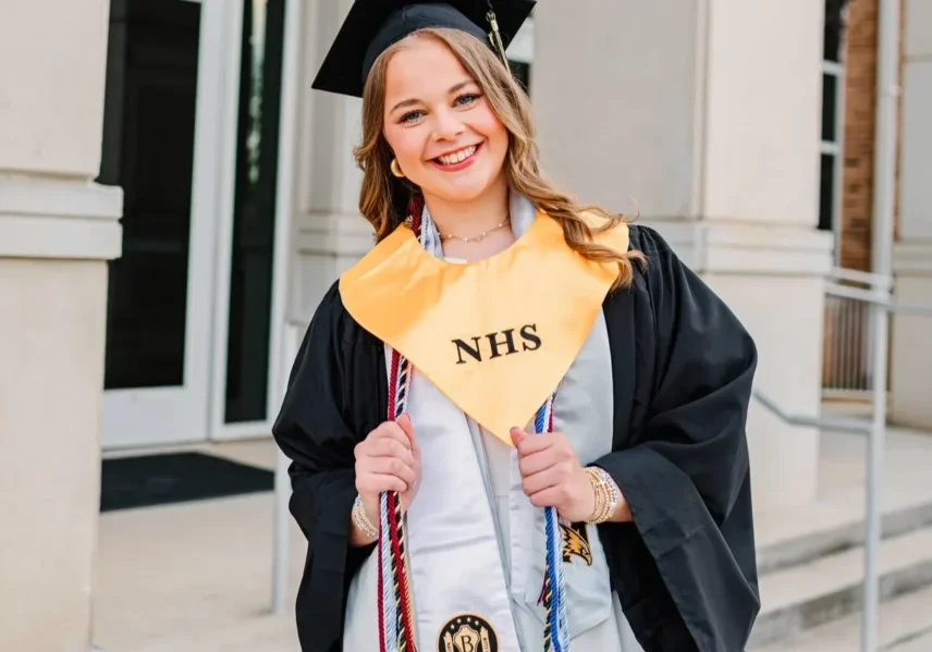 Graduate smiling in cap and gown