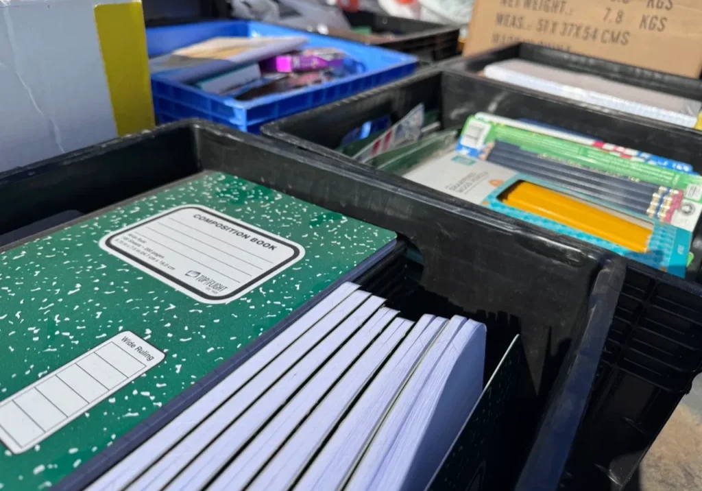 School supplies organized in black bins
