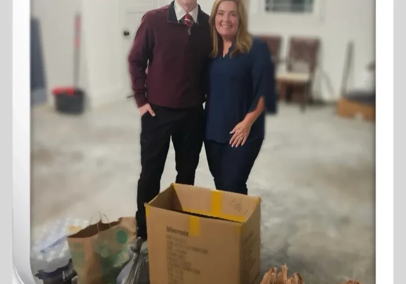 Two people with donation boxes and bags