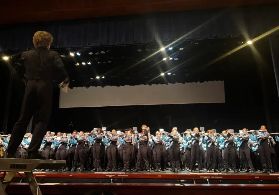 Conductor leads band on stage